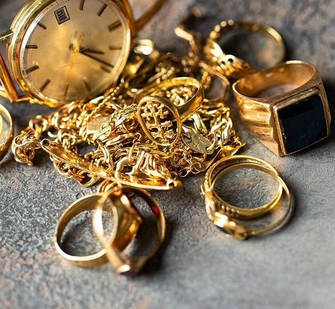 Pile of broken and old jewellery, rings, watch and chains. 